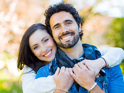 A smiling couple posing for a photograph.